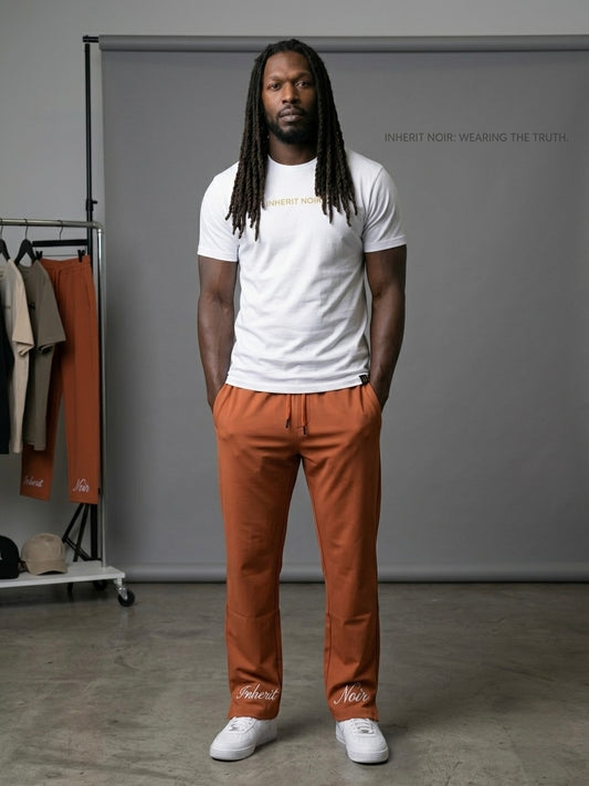 Inherit Noir Relaxed Fit Signature Joggers in Orange. Flat-lay product detail.