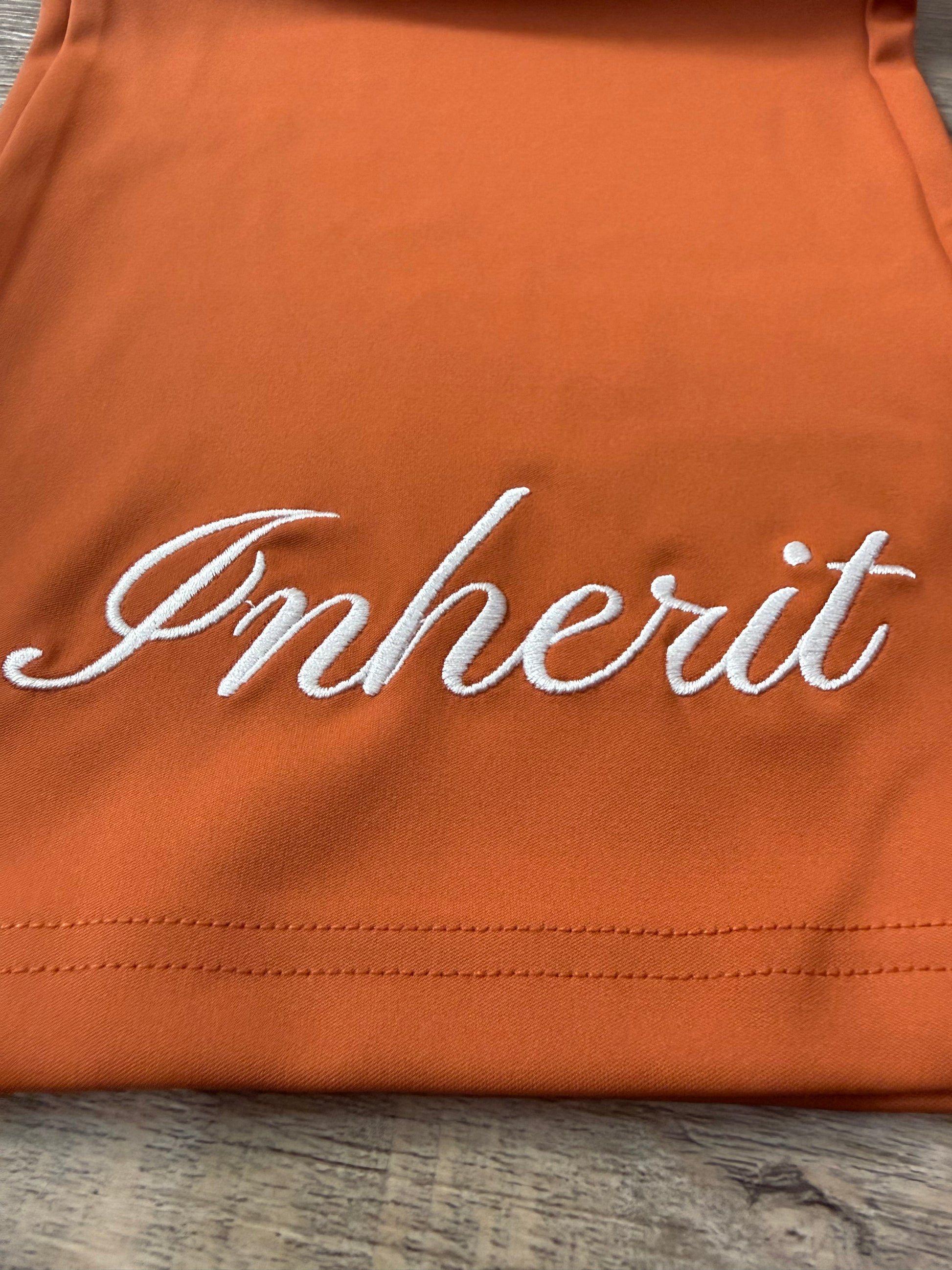 Inherit Noir Relaxed Fit Signature Joggers in Orange. Flat-lay product detail.