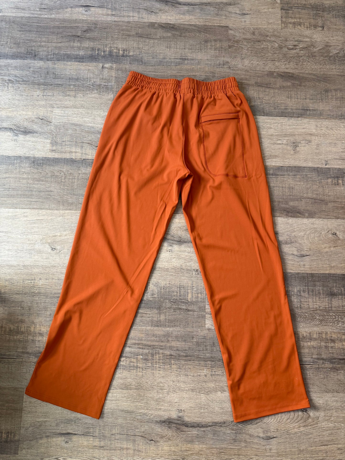 Inherit Noir Relaxed Fit Signature Joggers in Orange. Flat-lay product detail.
