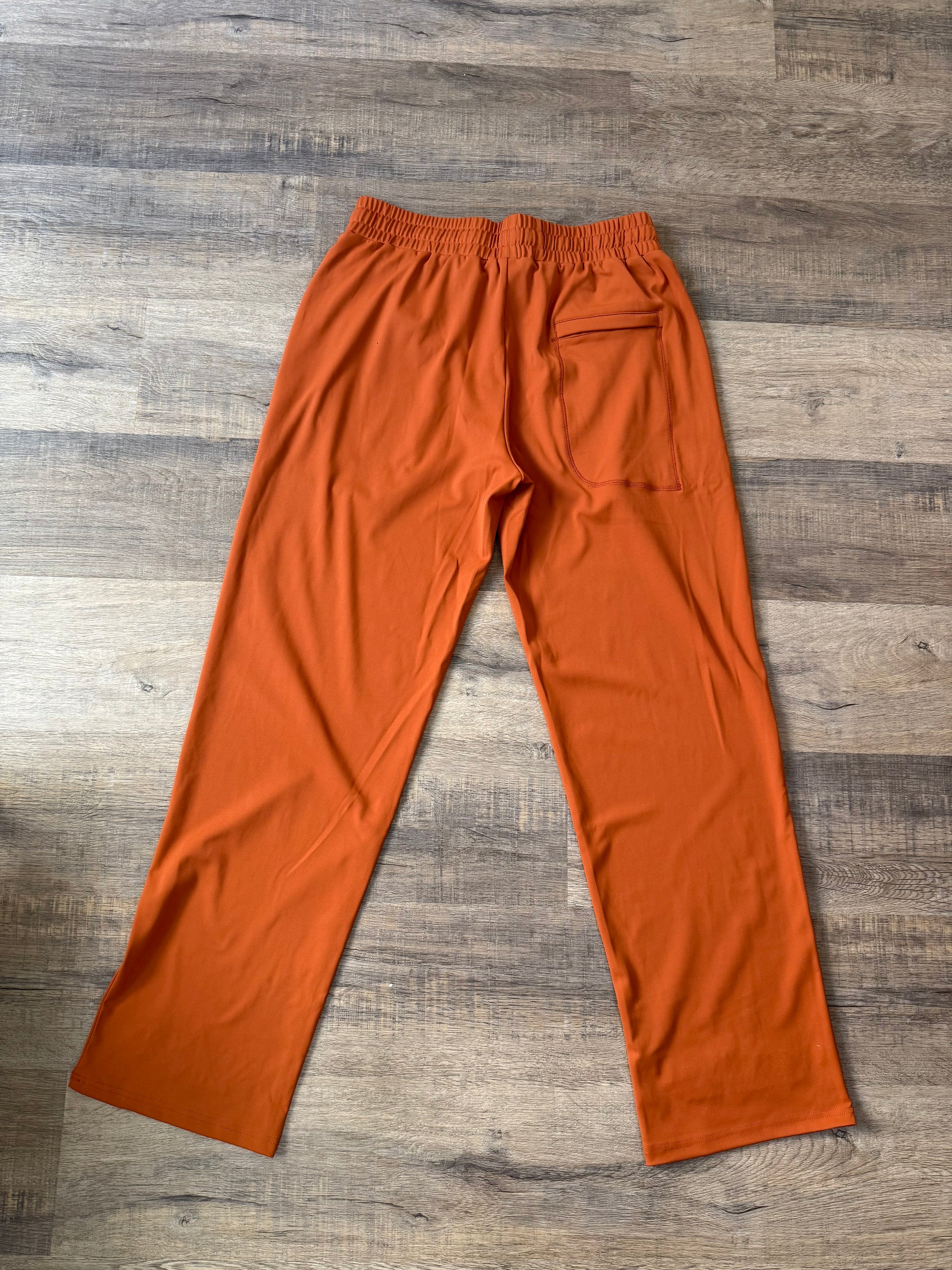 Inherit Noir Relaxed Fit Signature Joggers in Orange. Flat-lay product detail.