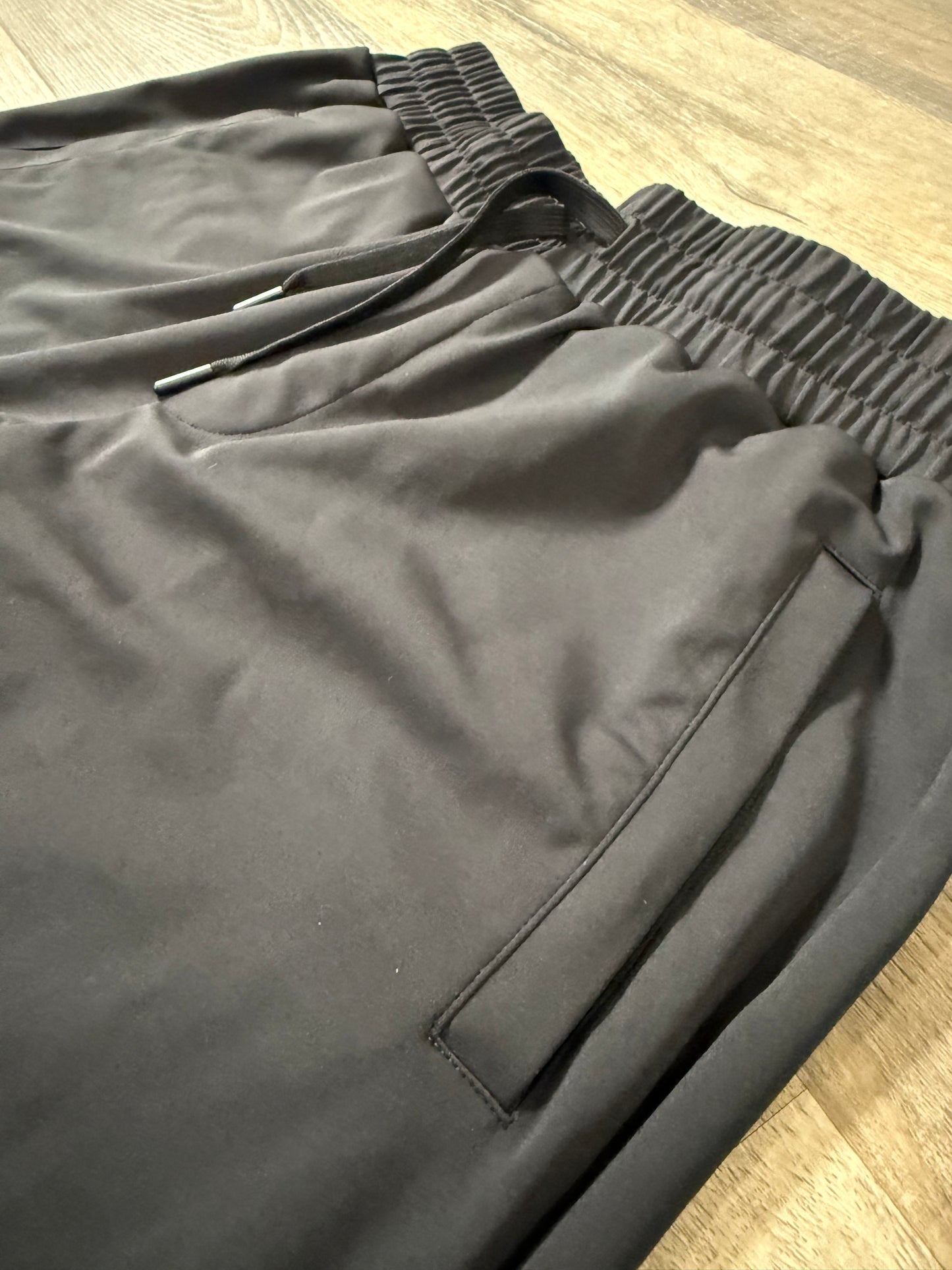 Inherit Noir Relaxed Fit Signature Joggers in Black. Flat-lay product detail.