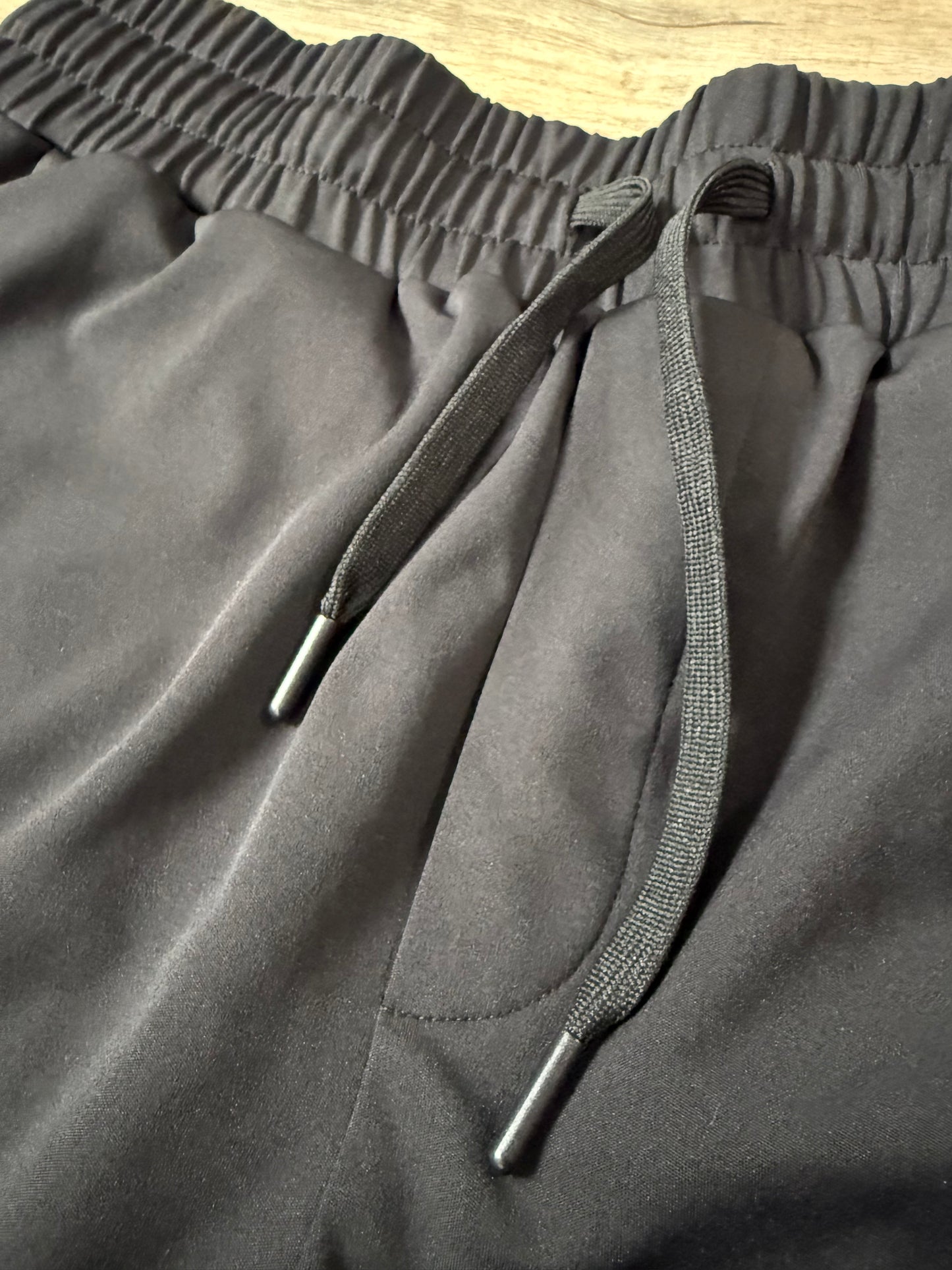 Inherit Noir Relaxed Fit Signature Joggers in Black. Flat-lay product detail.
