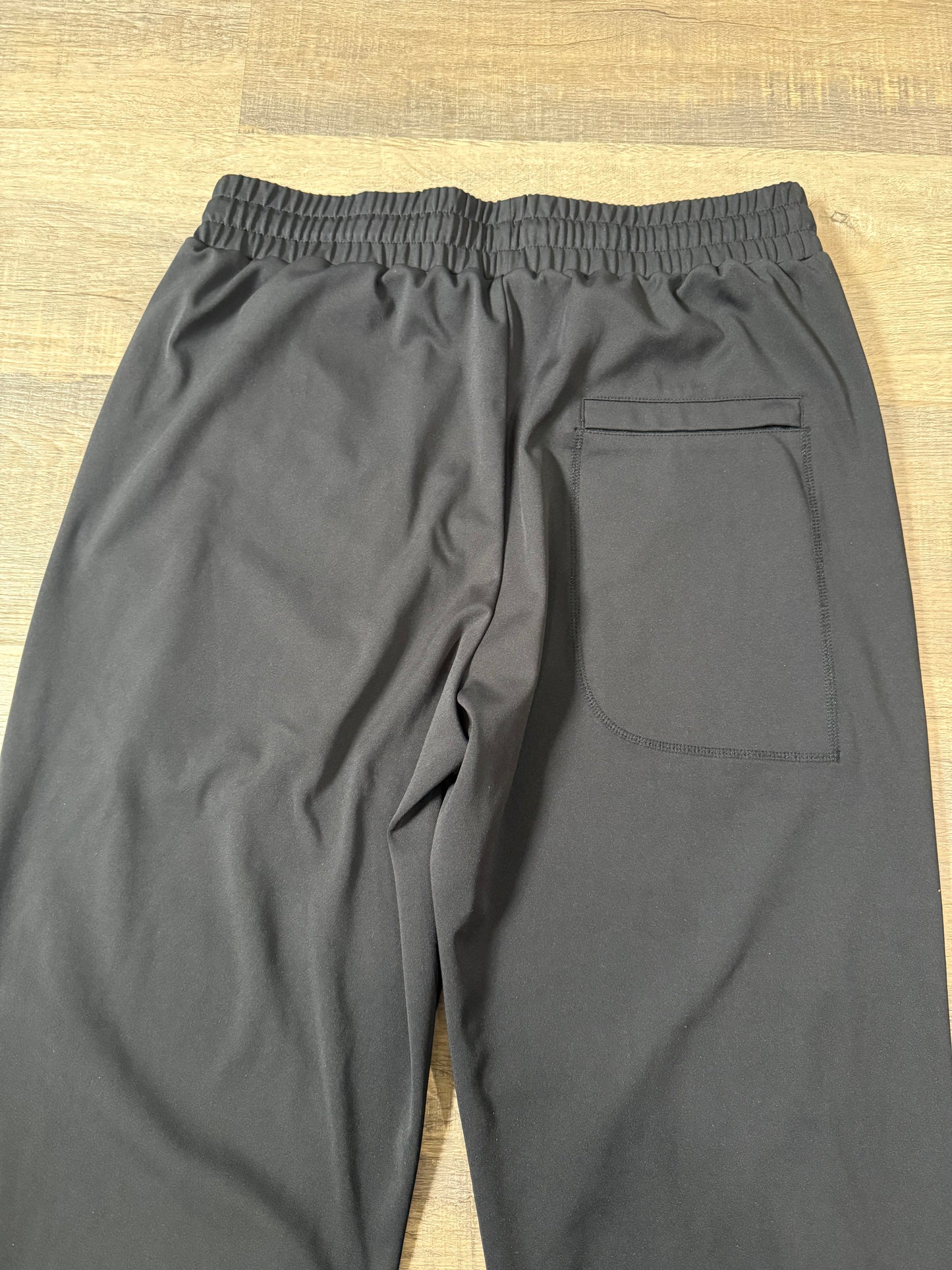 Inherit Noir Relaxed Fit Signature Joggers in Black. Flat-lay product detail.