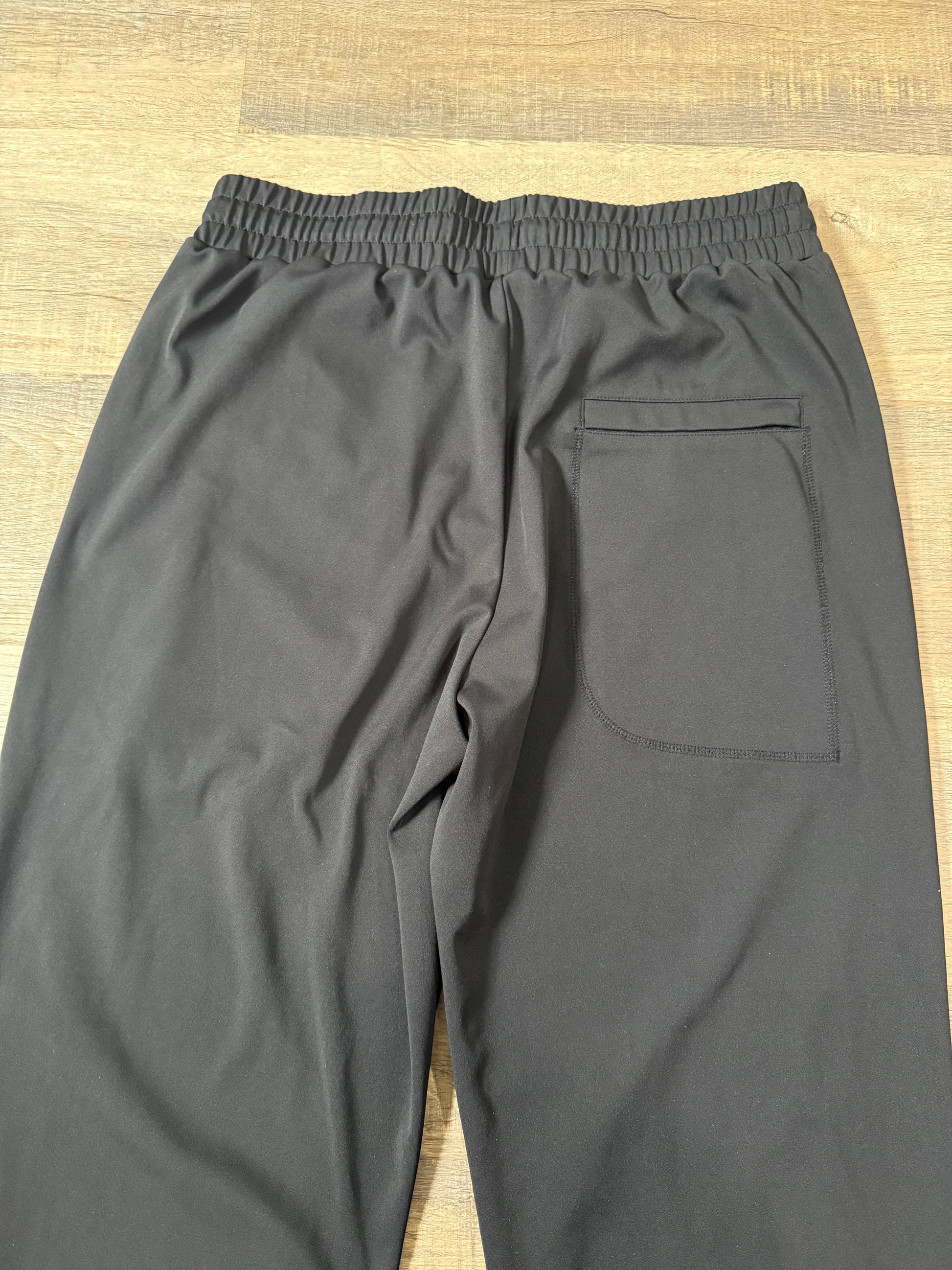 Inherit Noir Relaxed Fit Signature Joggers in Black. Flat-lay product detail.