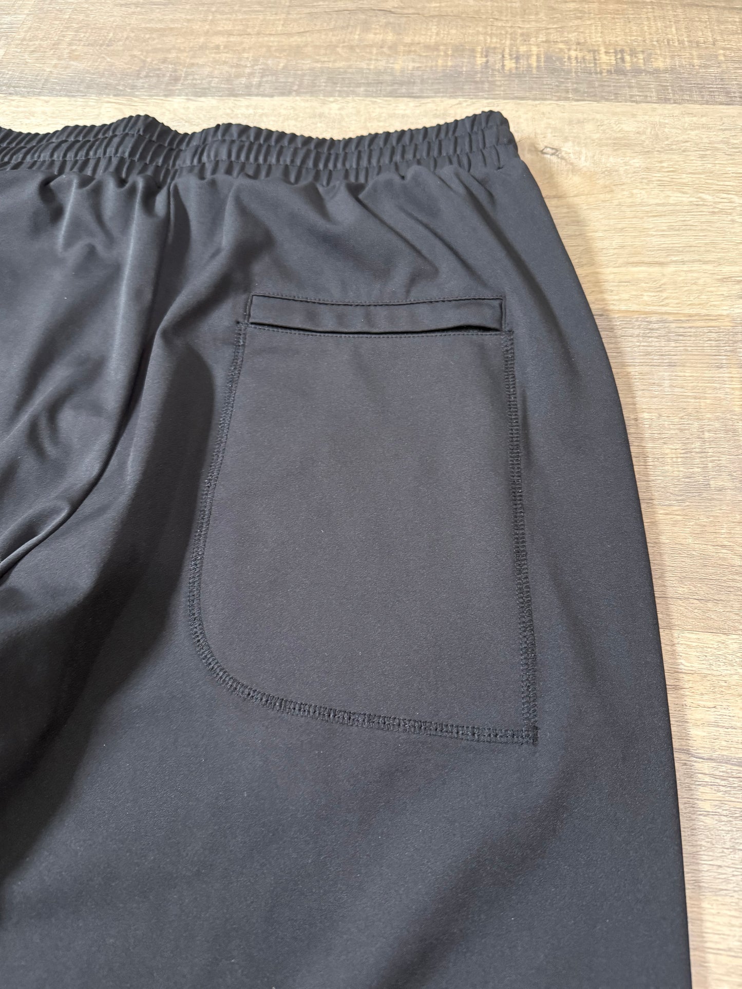 Inherit Noir Relaxed Fit Signature Joggers in Black. Flat-lay product detail.