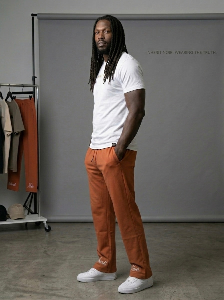 Inherit Noir Relaxed Fit Signature Joggers in Orange. Flat-lay product detail.