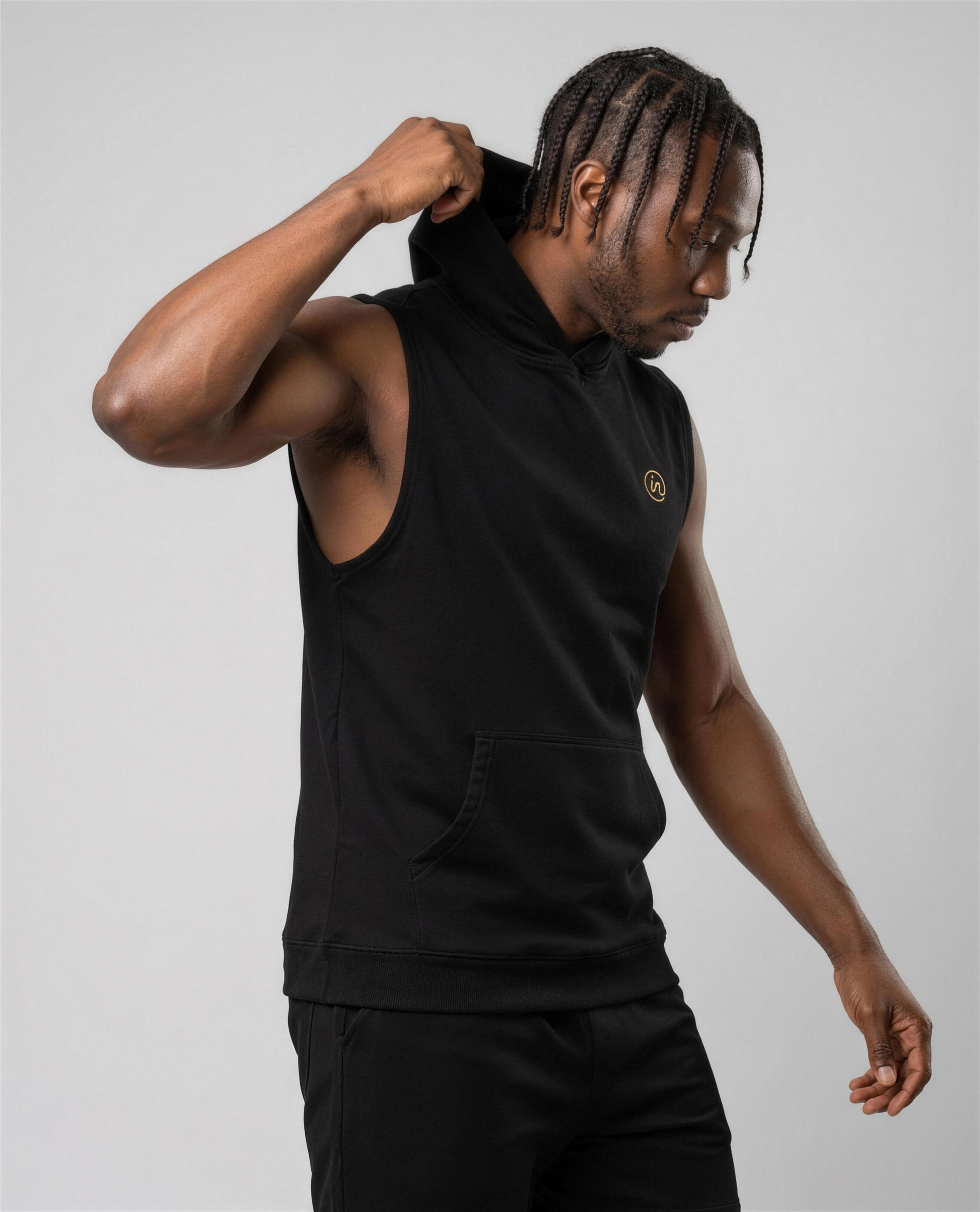IN Sleeveless Hoodie Black — studio 3/4 action on-model
